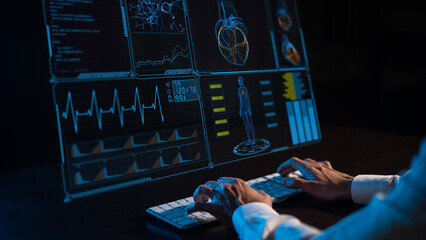 Close-up of male hands on a keyboard in the dark in front of a virtual menu. Readings on the life support monitor. 