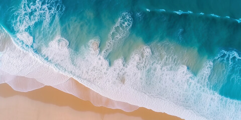 Obraz premium Ocean waves on the beach as a background. Beautiful natural summer vacation holidays background. Aerial top down view of beach and sea with blue water waves