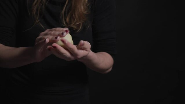 taking a piece of potato dough in hand and preparing to fill it with the plum