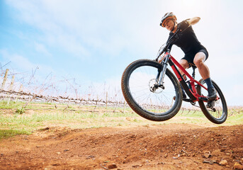 Bicycle, countryside and woman on a bike with speed for sports race on a dirt road. Fitness,...