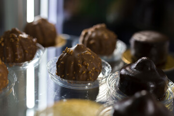 Chocolate cakes on a glass showcase.
