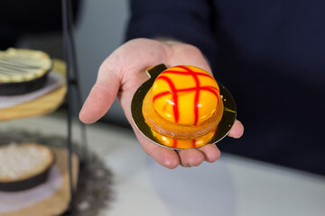 yellow orange round cake on hand