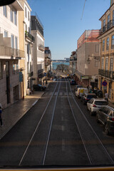 Lisbon street with tram rails and parked cars
