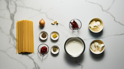 Mexican pasta ingredients. Pasta with sauce based on sour cream and heavy cream, butter and stock. Spicy with chili, onions, and garlic