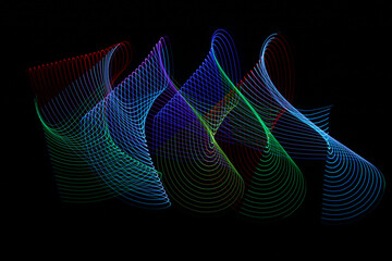 Letter S shaped swirls of vibrant, abstract, multicolored LED light trails on a black background.