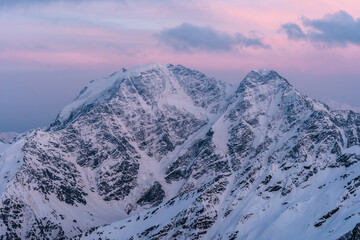 Snowy mountains at sunset. Beautiful landscape with snowy rocks
