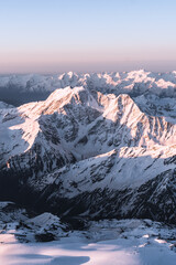 Snowy mountains at sunrise. Beautiful landscape with snowy rocks
