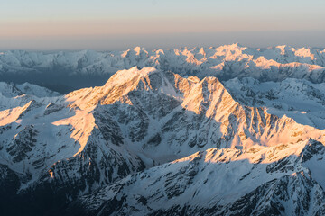 Snowy mountains at sunrise. Beautiful landscape with snowy rocks