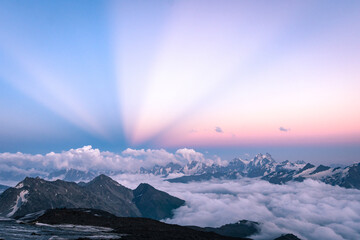 Anticrepuscular rays in the mountains, atmospheric optical phenomenon in the mountains above the clouds