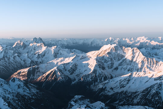 Snowy mountains at sunrise. Beautiful landscape with snowy rocks