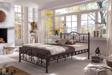 interior of a bedroom with metal bed base and mattress , sleep concept .