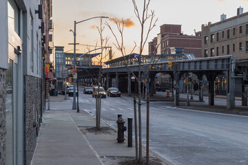 Cold morning on street in Brooklyn with Long Island Railroad train station passing through background - 592282450