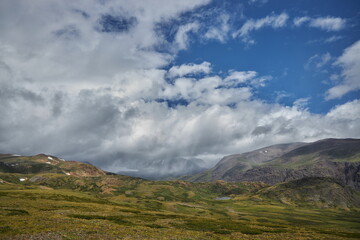 Hiking in the mountains. Rivers and mountain lakes, summer landscape of ridges and peaks. An amazing journey
