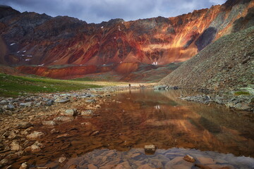 Hiking in the mountains. Rivers and mountain lakes, summer landscape of ridges and peaks. An amazing journey