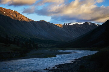 Hiking in the mountains. Rivers and mountain lakes, summer landscape of ridges and peaks. An amazing journey