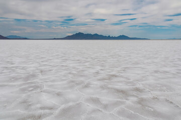 Scenic view of Bonneville Salt Flats in western Utah with Silver Island Mountains peaks in the background, Wendover, USA, America. Densely packed salt pan and natural landscape near Salt Lake City