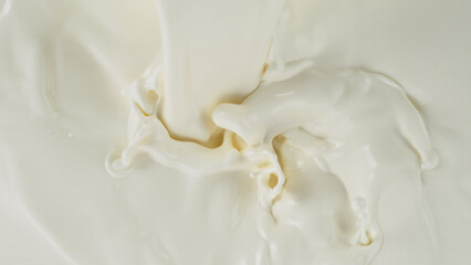 Freeze motion of whirling milk cream, close-up
