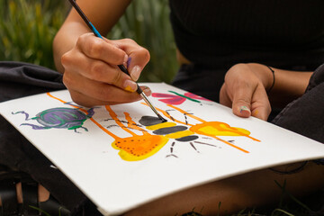 Crop artist painting on paper