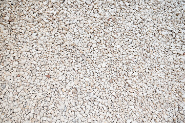 Road gravel, crushed stone. Gravel texture. Crack stones at a construction site. Seamless texture of white stones or gravel