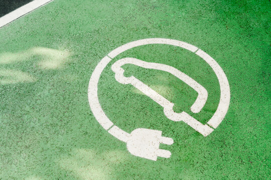 Electric car charger sign on ground