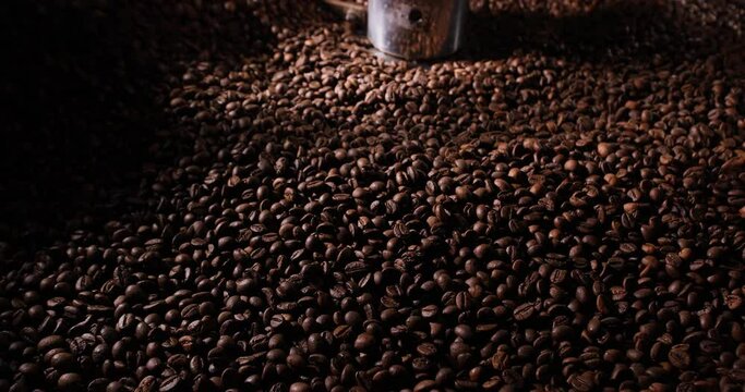 Professional coffee roasting machine. Close-up of arabica coffee beans. Concept coffee production.