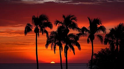 Stof per meter A fiery red and orange sunset over the ocean, with palm trees silhouetted against the sky. © Valentin