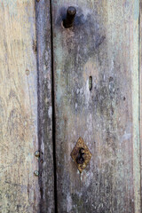 old unpainted wooden gate with rusty hardware