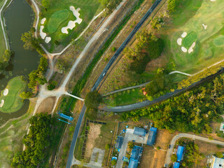 Aerial view drone Top down shot of beautiful green golf field High angle view in sunset time