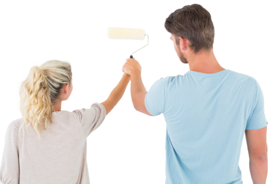 Young couple painting with roller