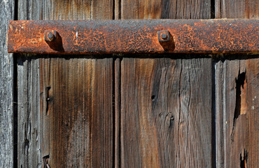 old unpainted wooden gate with rusty hardware