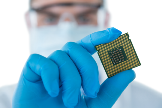 Male doctor in protective glasses and surgical mask holding electronic chip