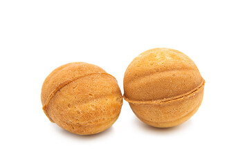Cakes in the form of nuts with cream isolated on a white background.