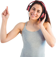 Portrait of smiling woman listening music through headphones