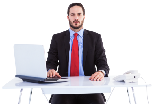 Unsmiling businessman sitting at desk - Powered by Adobe