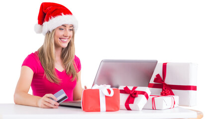 Festive blonde shopping online with laptop