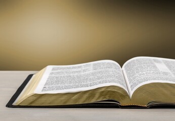 Open Bible book on wooden table