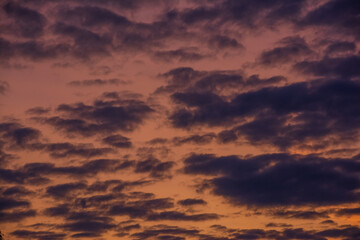 Dark clouds at sunset with orange sky