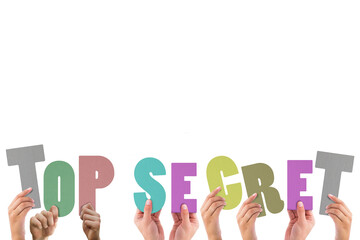 Cropped hands holding colorful alphabets forming top secret