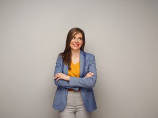 Portrait of smiling woman in blue suit and yellow shirt looking at side.