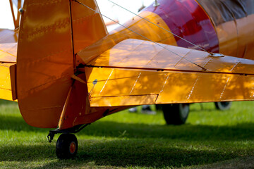 Yellow old plane over the field, horizontal photography of a section of the biplane
