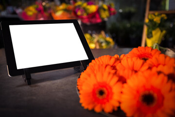 Fresh flowers against digital tablet