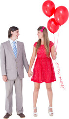 Smiling geeky couple standing hand in hand 