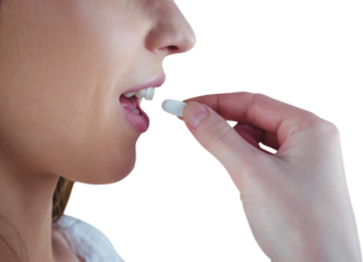 Close up of woman taking white pill