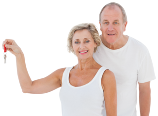 Mature couple smiling at camera with new house key