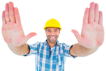 Smiling manual worker gesturing stop sign