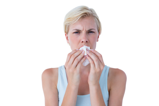 Portrait of attractive woman blowing her nose