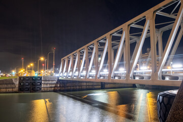 Obraz premium Night view of illuminated bridge above of river Scheldt in Antwerp, Belgium. High quality photo