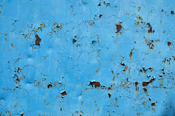 Blue painted metal surface with rust showing through, surface texture