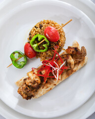 Chicken skewers - grilled meat with  vegetables on white background. Chicken kebab skewers.