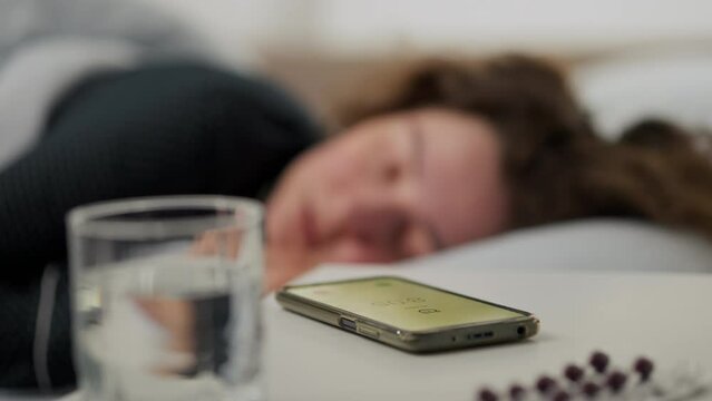 Clock, Middle-aged woman Quietly Turns off the alarm signal In her house, General view Young housewife Feels sleepy In order not to be late for an earlier meeting, wake up

